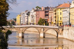 SARAJEVO, BOSNIA AND HERZEGOVINA - SEPTEMBER 4, 2009: Latin Bridge and Obala Kulina Bana street that runs along the right bank of the Miljacka river.