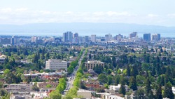 View of Downtown Oakland with Berkeley in the foreground, view from above University of California Berkeley on an overcast hazy Northern California day.