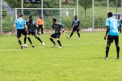 SCHARNHAUSEN, GERMANY - MAY 14, 2016: The team of TSV Scharnhausen is playing a friendly match of soccer against a team of refugees that is residing in a camp in Scharnhausen for 6 months now. Since a