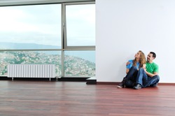 happy young couple have fun and relax at comfort bright apartment and work on laptop computer happy young couple have fun and relax at comfort bright appartment and work on laptop computer