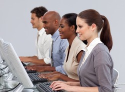 Serious International business team working at computers in the office