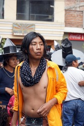 COTACACHI, ECUADOR - JUNE 30, 2016: Inti Raymi, the Quechua solstice celebration, with a history of violence in Cotacachi. A young man in an orange jacket dances in the circle.
