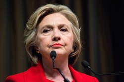 NEW YORK, NY, USA - APRIL 13, 2016: Hillary Clinton in a red suit pauses with a facial expression fit for currency as she gives a speech at the National Action Network's 25th annual convention,