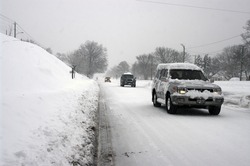 FALLS CHURCH, VA - FEBRUARY 6: Vehicles make their way on Arlington Boulevard in the record blizzard of the Washington DC area on February 6, 2010 in Falls Church, VA.