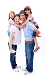 Loving parents giving their children a piggyback ride against a white background