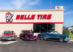 ROYAL OAK, MI/USA - AUGUST 18, 2016: A 1966 Dodge Charger, 1935 Ford Tudor, 1951 Buick Super cars at Belle Tire, on the Woodward Dream Cruise route. Woodward is a National Scenic Byway.