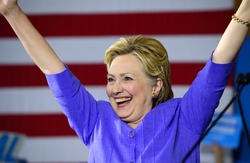 CINCINNATI, OHIO, USA - JUNE 27, 2016: Hillary Clinton victory gesture with raised arms at a campaign event in the Museum Center with Senator Elizabeth Warren.