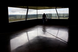 SHANKSVILLE, PA - AUGUST 17: An unidentified man looks through a window at the Flight 93 National Memorial Visitor Center near Shanksville, PA on August 17, 2016. The window overlooks the impact site.