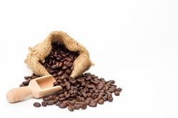 Organic coffee beans in sack on white background close up isolated.(Droped space on right side for text and other.)