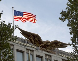 London, United Kingdom - September 23, 2016: The American Flag. The American flag on the embassy in London catches the evening sunset making it glow.