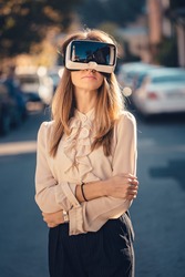 virtual reality headset, virtual reality, VR glasses, augmented reality, VR goggles - happy young girl with virtual reality headset or 3d glasses stay sitting on the street interested by 360 image