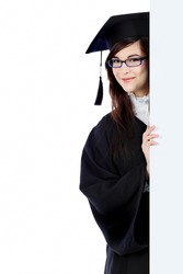 Educational theme: graduating student girl in an academic gown holding a billboard. Isolated over white background.
