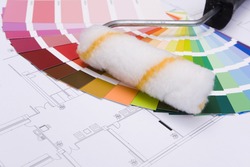 Color samples for selection and a a painter´s roll with house plan on background