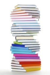 Stack of rainbow colored real books in spiral formation, side view, isolated on white background