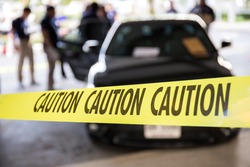 caution tape or police line protect vehicle in crime scene investigation training in academy with blurred law enforcement background