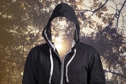 Person with blank face outdoors. Spirituality, lost identity and ecological psychology concept.