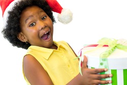 Close up portrait of exited little african kid holding if christmas gift.Isolated on white background.