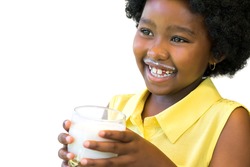 Close up portrait of happy african girl holding glass with milk. Isolated on white background.