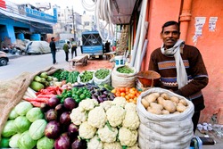 DELHI - JAN 31: Vegetable street vendor with his mobile stand on January 31, 2008 in Delhi, India. Most mobile vendors are illegal and have to either run away from the police or pay them bribes.
