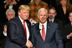 HERSHEY, PA - DECEMBER 15, 2016: President-Elect Donald Trump and Vice President-Elect Mike Pence shake hands on stage at a Thank You rally held at the Giant Center.