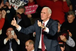 HERSHEY, PA - DECEMBER 15, 2016: Vice President-Elect Mike Pence gives a thumbs up gesture as he arrives on stage to deliver a speech to a large crowd at a Thank You rally held at the Giant Center.