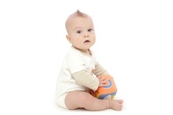 Baby boy sitting and playing with a colorful block, on white background