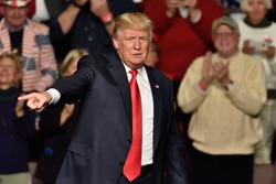 HERSHEY, PA - DECEMBER 15, 2016: President-Elect Donald Trump points right toward the crowd as he concludes his speech at a "Thank You Tour" rally held at the Giant Center.