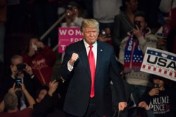 HERSHEY, PA - DECEMBER 15, 2016: President-Elect Donald Trump gives a "Fist Pump" to the crowd as he arrives on stage to deliver a speech at a "Thank You" Tour rally at the Giant Center.