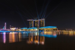Singapore City, Singapore - July 17, 2012: Marina Bay skyline and Merlion in the night. The Marina Bay is a bay near Central Area in of Singapore, and lies to the east of the Downtown Core.