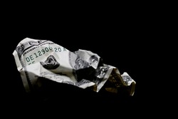 crumpled one hundred dollar bill macro, shot over black. limited depth of field with primary focus on benjamin franklin's eye