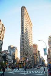 NEW YORK CITY - DEC 7: Flat Iron building, considered to be one of the first skyscrapers ever built, with New York City street view. December 7, 2009 in Manhattan, New York City.