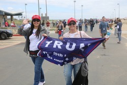 Huntington Beach, CA - March 25 2017: Make America Great Again March. Supporters and protesters of republican president Donald Trump, wave flags, and hold signs at a MAGA March in Huntington Beach.
