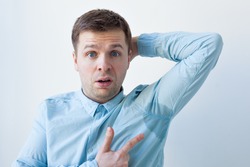 Caucasian, young man is worried and shows sweating stain problem with sweating - hyperhidrosis