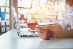 asian young woman hands holding credit card and using laptop smart phone Online shopping.Online shopping concept