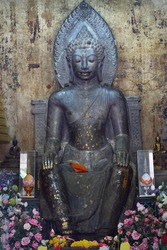 black sitting buddha statue in the temple at Ayuttaya province, Thailand. This is very old buddha statue.