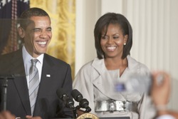 WASHINGTON - JUNE 29: US President Barack Obama with the first lady Michelle Obama next to him gives speech from the East Room of the White House June 29, 2009 in Washington, DC