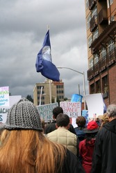 April 22 2017 Olympia WA USA Earth Day flag is carried proudly above the crowd as they move through downtown at the March for Science