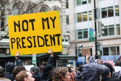 Washington, DC - January 20, 2017: On Inauguration Day, protesters fill the streets to voice their opposition to the election of President Donald Trump.
