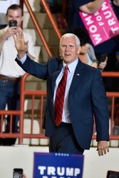 HARRISBURG, PA - APRIL 29, 2017: Vice President Mike Pence waves to supporters as he arrives on stage at a Trump campaign rally marking 100 days in office at the Farm Show Complex and Expo Center.