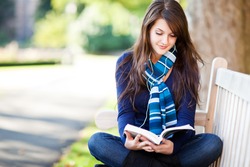 A portrait of a mixed race college student studying at campus