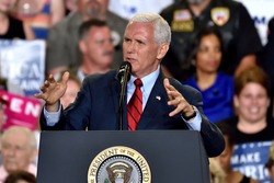 HARRISBURG, PA - APRIL 29, 2017: Vice President Mike Pence gestures as he speaks to supporters at a Trump campaign rally marking 100 days in office at the Farm Show Complex and Expo Center.