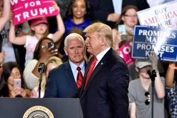 HARRISBURG, PA - APRIL 29, 2017: President Trump and Vice President Pence switch positions on stage at the 100 day mark of their administration. Held at The Farm Show Complex and Expo Center.