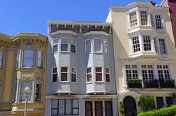 Tightly packed bright colorful houses on steep streets in San Francisco California