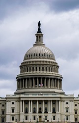 A high contrast close up of the dome of the US Capitol Dome on an overcast day.