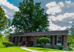 Kentucky charming ranch home with disability ramp, giant oak in back and beautiful green yard with blue sky and clouds urban exploration photography 2017