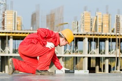 builder worker checking horizontal with digital level tool at construction site