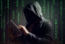 Computer hacker with digital tablet stealing data concept for network security, cyber attack or ransomware