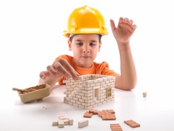 Cute boy building house isolated on white - a series of BUILDING A HOUSE images.