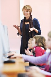 it education with children group in school at computer science class learning leassons and practice typing
