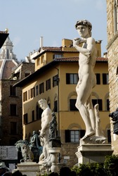 the square in Florence, Italy, showing many statues, statue of David in the foreground